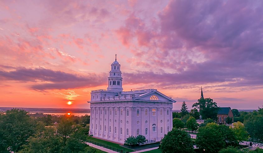 Aerial view of Nauvoo Temple above the Mississippi River at sunrise.