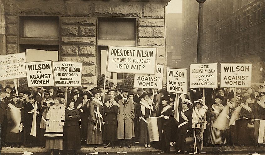 Crowd of women's suffrage supporters demonstrating with signs reading, 'Wilson Against Women,' in Chicago on October 20, 1916