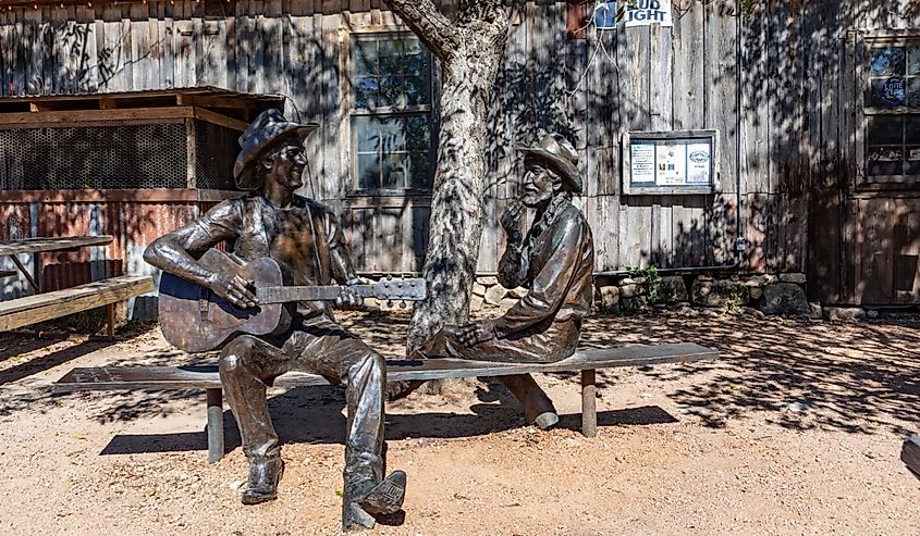 Jerry Jeff Walkers Hondo Crouch Statue of a cowboy playing guitar Unveiled in Luckenbach, Texas