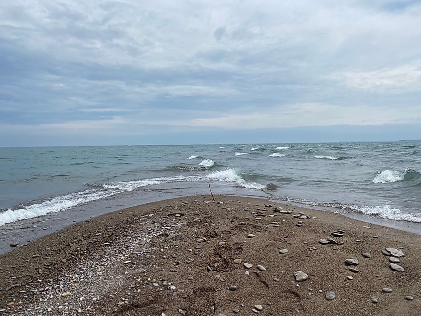 A simple wooden stick planted in the sand at the southernmost tip of Fish Point on Pelee Island.