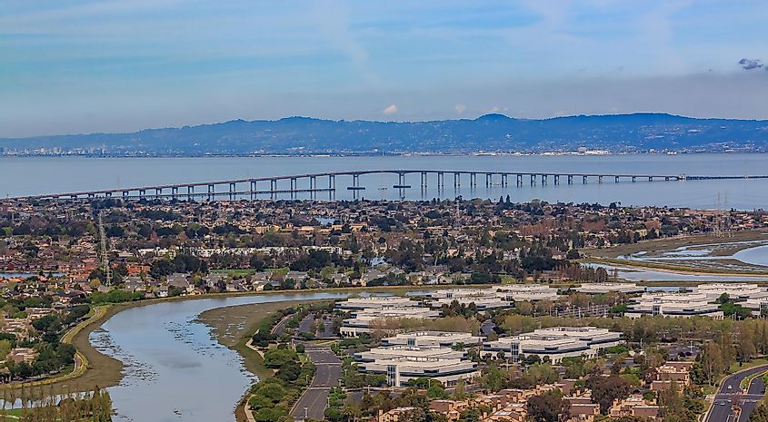 Aerial view from an airplane of San Mateo Hayward bridge across the San Francisco Bay and Foster City in San Mateo County, California