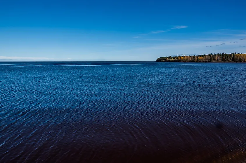 A frozen lake in Canada's Northwest Territories under a pale winter sky.