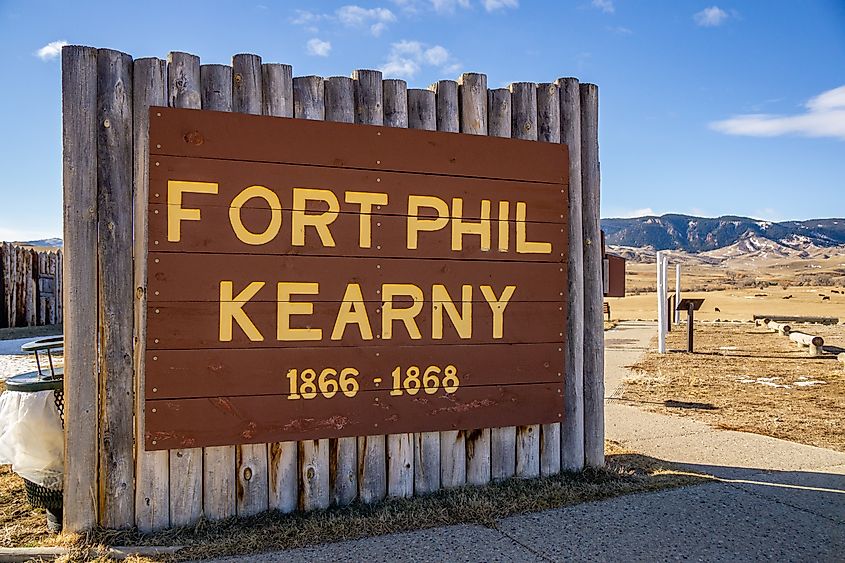 Fort Phil Kearny State Historic Site log post entrance sign written in yellow letters.