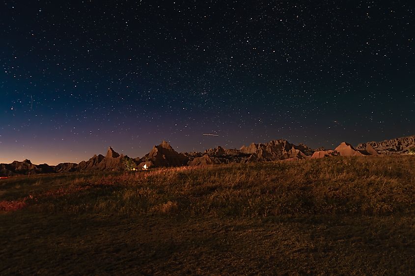Starry Night Sky over Rugged Rock Formations in Badlands National Park.