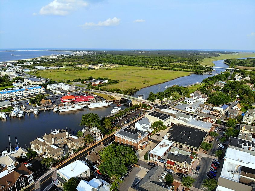 The aerial view of the beach town, fishing port and waterfront residential homes along the canal, via Khairil Azhar Junos / Shutterstock.com