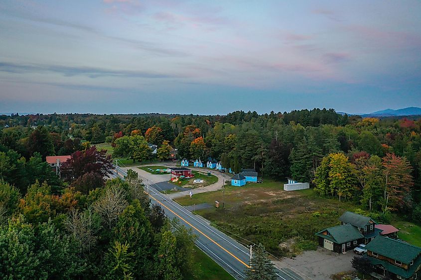 Sunset over Moody Tupper Lake in the Adirondacks, New York, captured in early fall from an aerial perspective.