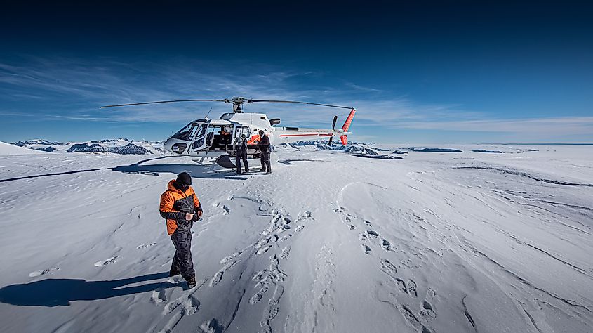 Scientists install experiments in dry valleys, Antarctica, via helicopter