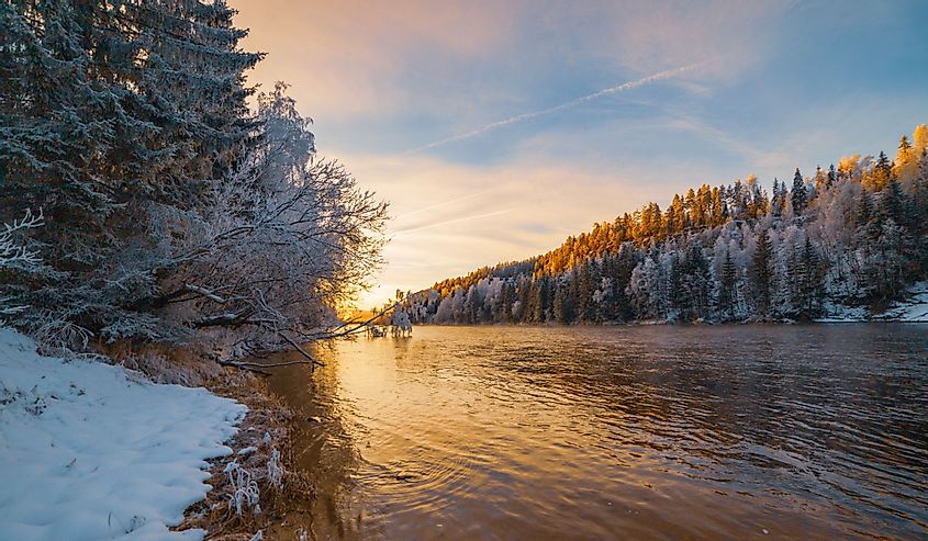 Rena river with snowy borders and sunset.