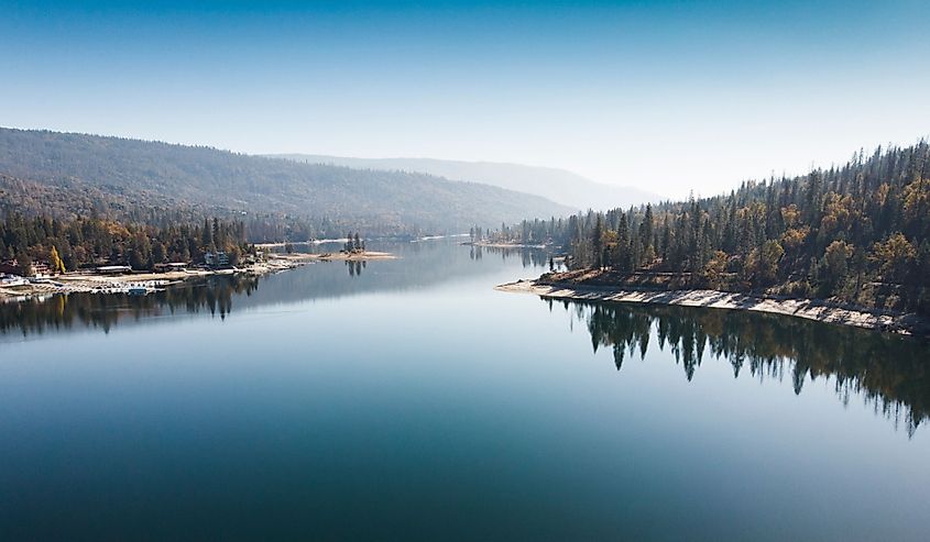 Aerial view of Bass Lake with reflection of forest in the clear water