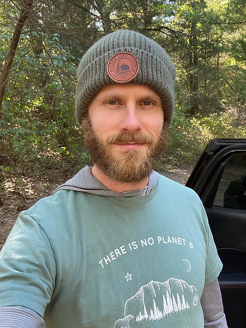 A man with a beard, green toque, and a green t-shirt that reads There Is No Planet B.