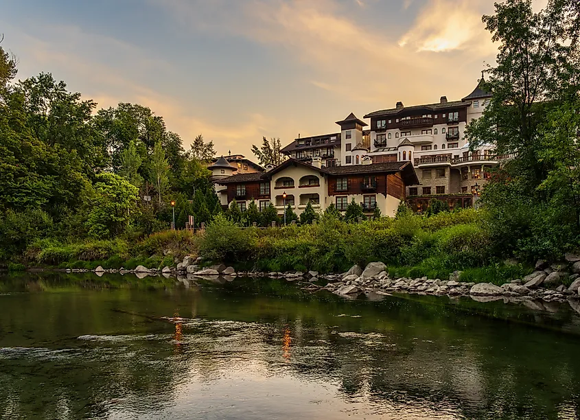 Hotel with multiple balconies by Wenatchee River in the Alpine German village of Leavenworth in Washington State
