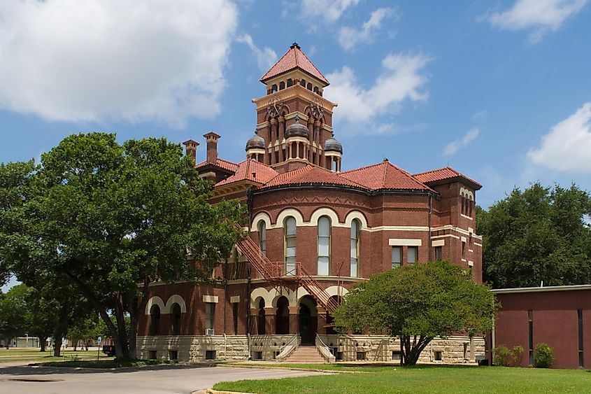 The Gonzales County Courthouse is a red brick three story eclectic Romasnesque Revival structure.