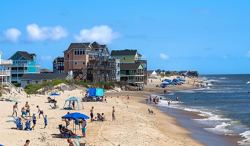 View of people and vacation homes on the beach as seen from the Rodanthe Pier in the Outer Banks