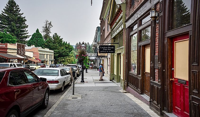 People spending time outside, walking this historic old town while smoke lingers in the air from the Carr fire, Nevada city, California 