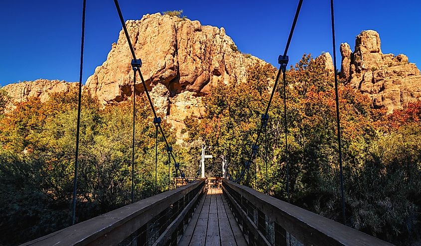 Wooden bridge in Boyce Thompson Arboretum Arizona, USA, magma rock at the backdrop