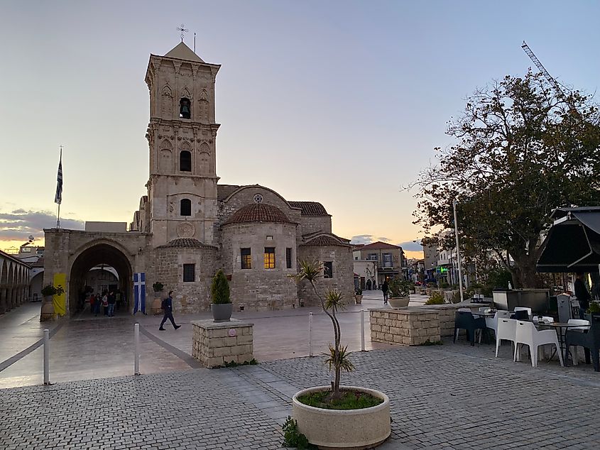 The evening's afterglow over a large stone Greek orthodox church.