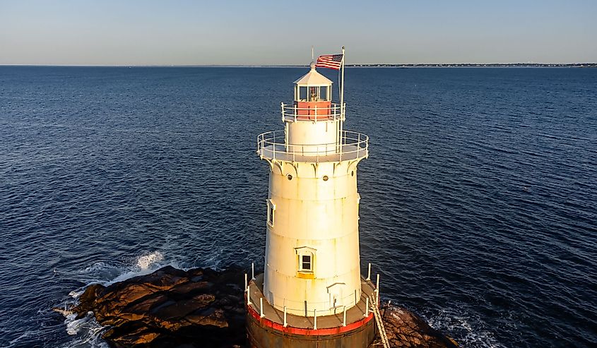 Early morning aerial image of the Sakonnet Point Light (West Island Light) between Little Compton and Tiverton Rhode Island, at Sakonnet River and Atlantic Ocean.