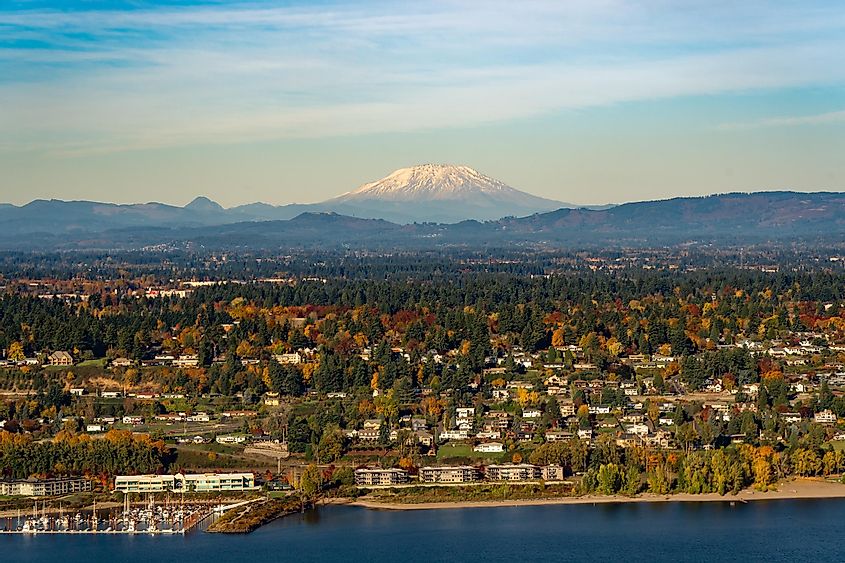 Mt Saint Helens, the columbia river, a boat mooring facility and fall color trees in Vancouver, Washington.