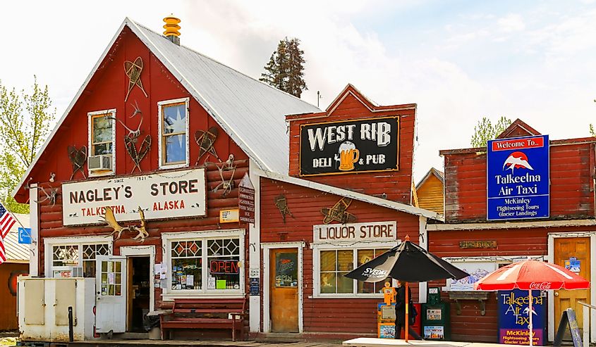 Facade of stores and pubs in the small oldtown of Talkeetna, Alaska. Residents and Tourists come here to get food, gifts, and other goods.