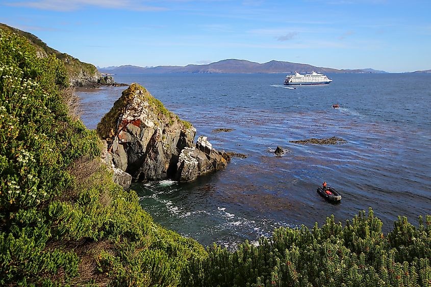 Cruise ship approaching the rocky coast of Cape Horn Island in Chile.