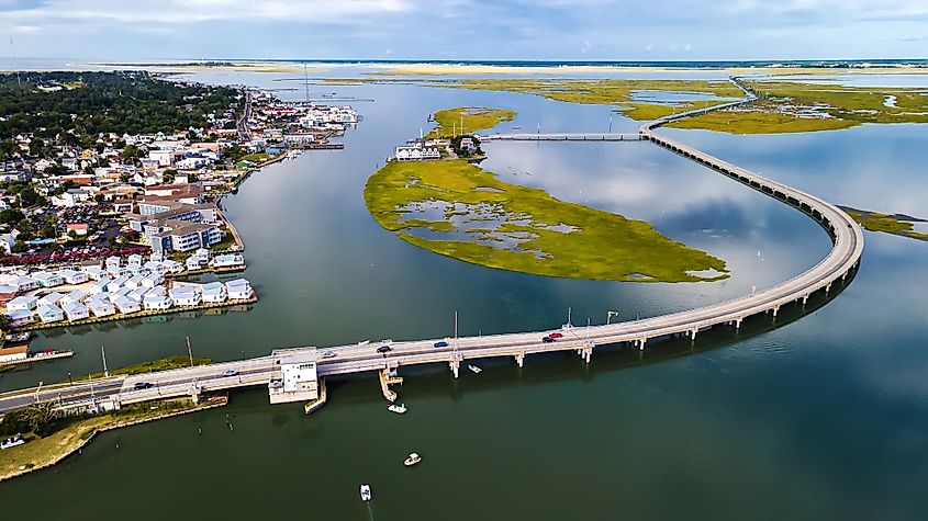 Drone view of Chincoteague bridge across the Chincoteague Bay in Virginia, showcasing views of the waterfront.
