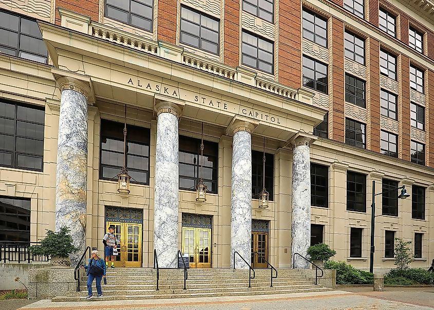 Couple walking down the steps of the Alaska State Capitol Building in downtown Juneau.