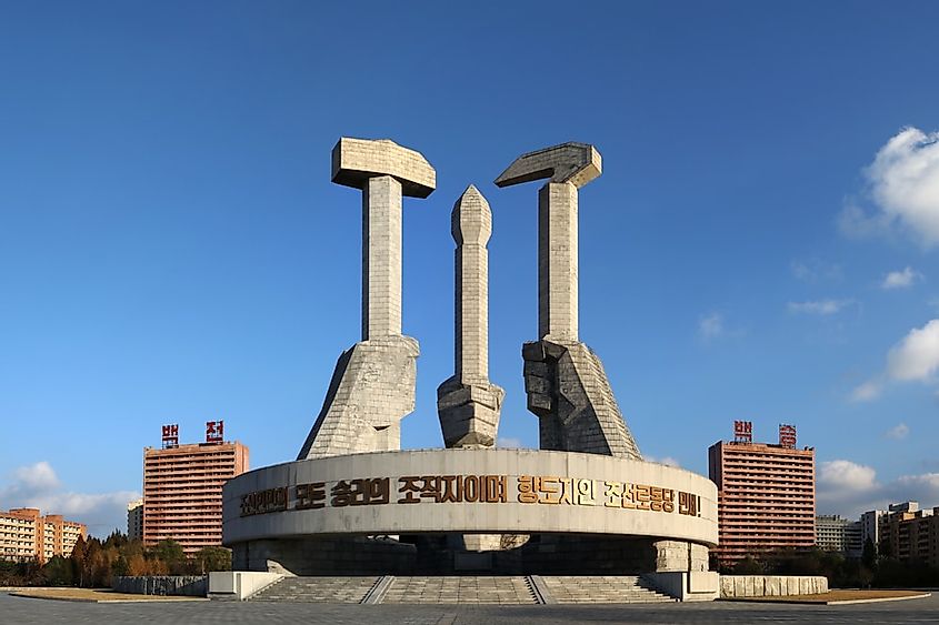Pyongyang, North Korea: Monument to the Founding of the Korean Workers' Party, featuring a 50-meter-high composition of a hammer, a sickle, and a writing brush.