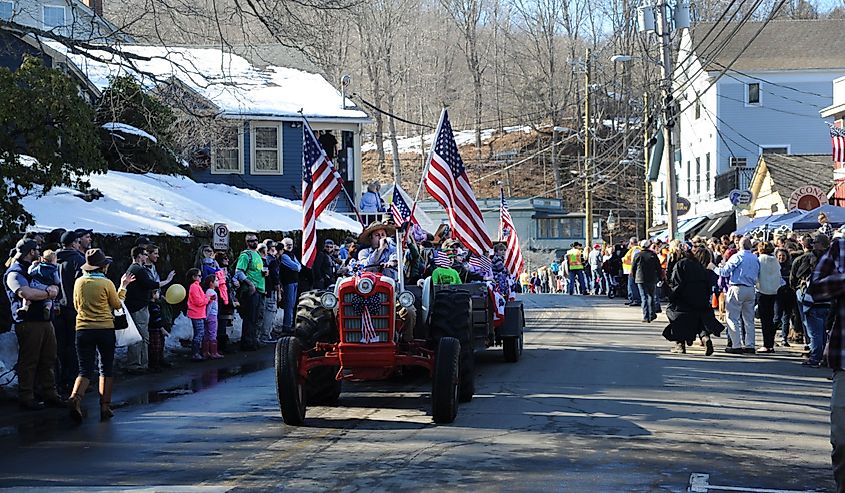 A tractor parade makes it's way through Chester, Connecticut during a winter festival.