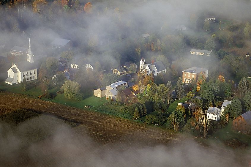 A dreamy aerial view of Waitsfield, Vermont, on a foggy day.