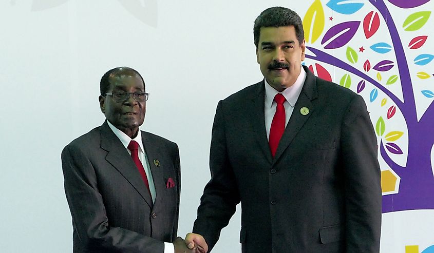 Robert Mugabe shaking hands with Venezuelan President Nicolas Maduro.