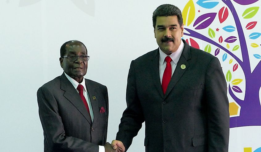 Robert Mugabe shaking hands with Venezuelan President Nicolas Maduro.
