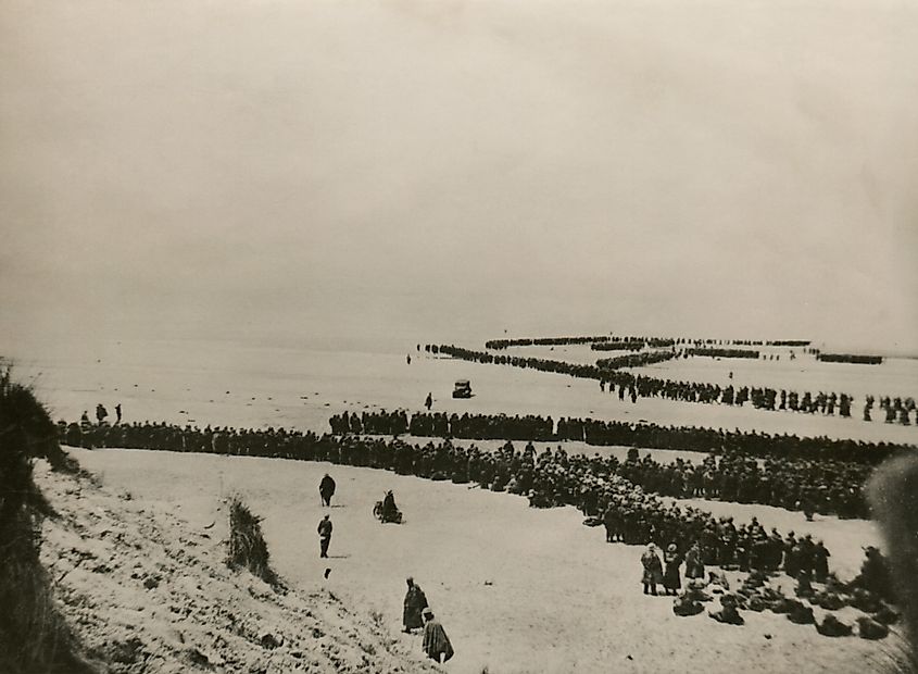 Military evacuation of Dunkirk during World War 2. Thousands of British and French troops wait on the dunes of Dunkirk beach for transport to England