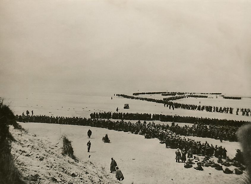 Military evacuation of Dunkirk during World War 2. Thousands of British and French troops wait on the dunes of Dunkirk beach for transport to England