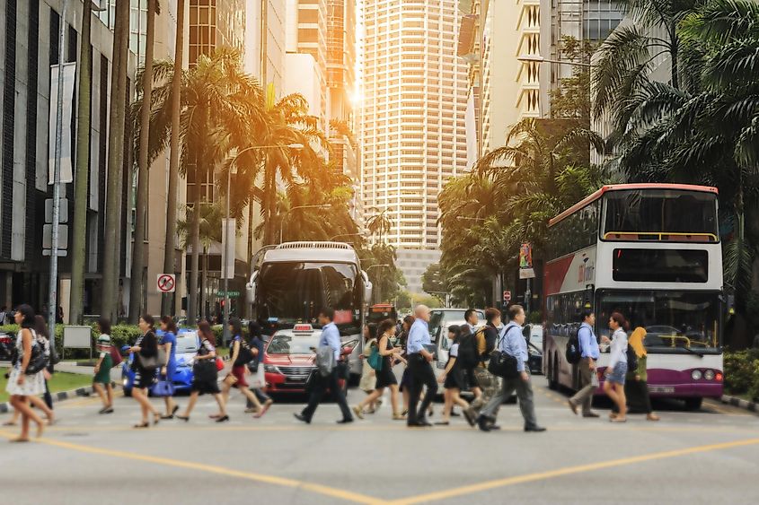 crowd of people walking on zebra crossing and traffic jam on Cross street in singapore.