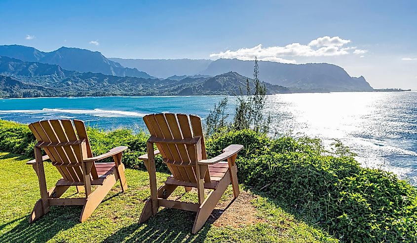 Lounging chairs overlooking Hanalei Bay and the Na Pali coast Princeville Kauai Hawaii USA