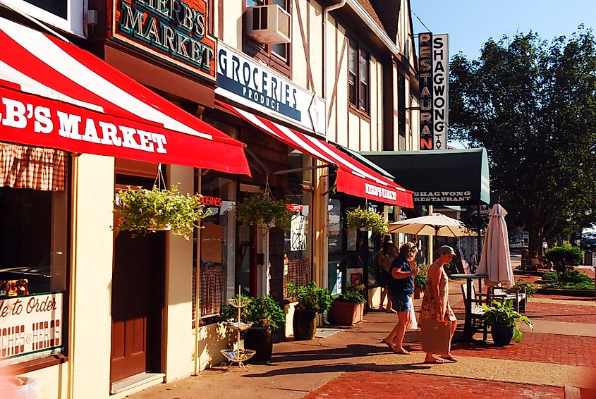 Editorial Photo Credit: James Kirkikis via Shutterstock. Montauk, NY, USA July 27 Two friends shop at a grocery store in downtown Montauk New York, on Long Island, on a summer day