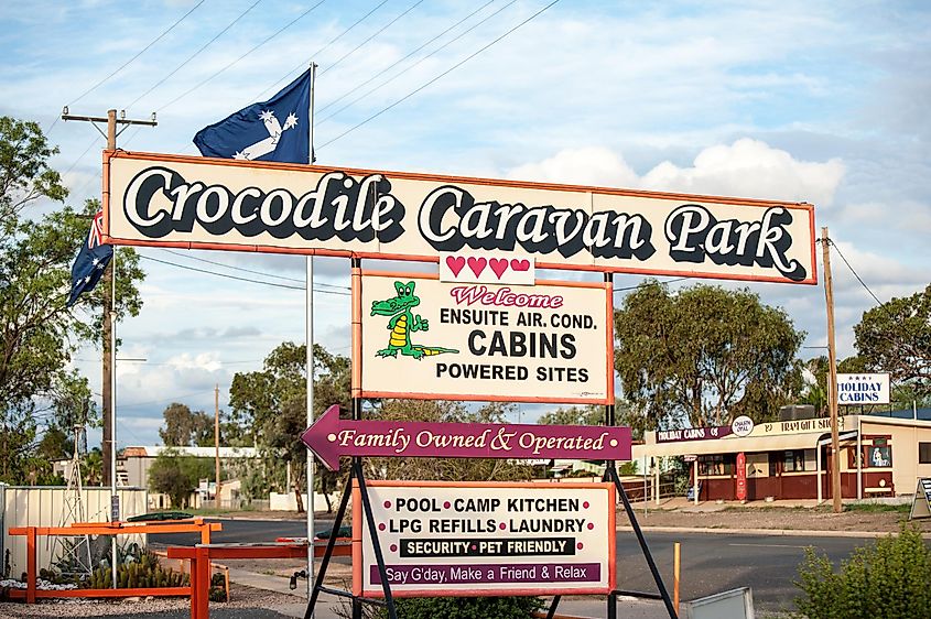 Crocodile Caravan Park frontage and sign for accommodation on the main street of Lightning Ridge, opal mining town in outback New South Wales, Australia