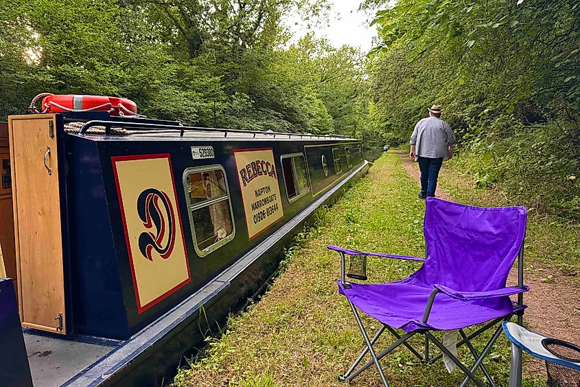 A canal boat moored as a person walks the towpath. Image credit: Bryan Dearsley