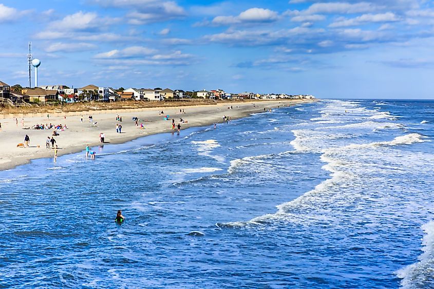 Residents and tourists flock to the Atlantic Ocean at Folly Beach near Charleston, South Carolina