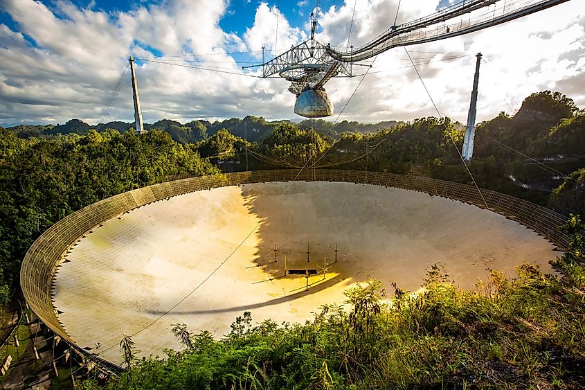 Large radio telescope dish in Arecibo national observatory. Via Shutterstock / Photo Spirit.