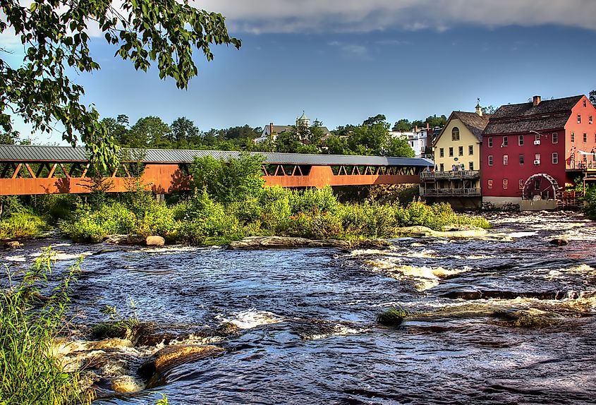 The Riverwalk Covered Bridge and the old grist mill on the Ammonoosuc River in Littleton, New Hampshire