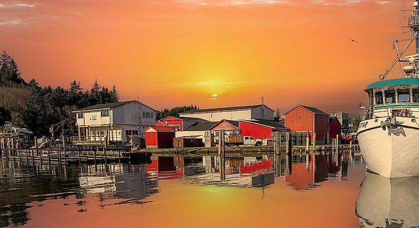 A moorage basin and fish processing plant at sunset at the mouth of the Columbia River at Ilwaco, Washington