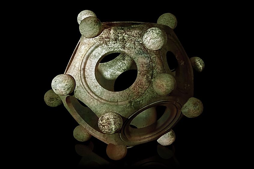 Ancient bronze Roman dodecahedron on a black background