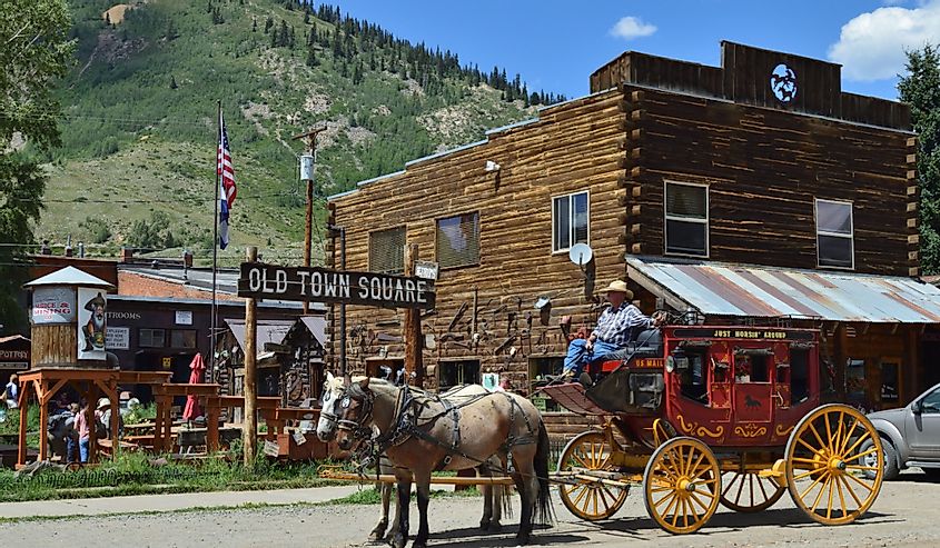 Silverton CO, USA : The old town square with horse and buggy, shops, and mountains in the background.