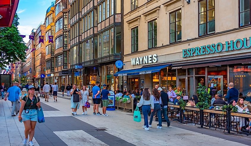 People are strolling through a busy street in central Stockholm, Sweden.