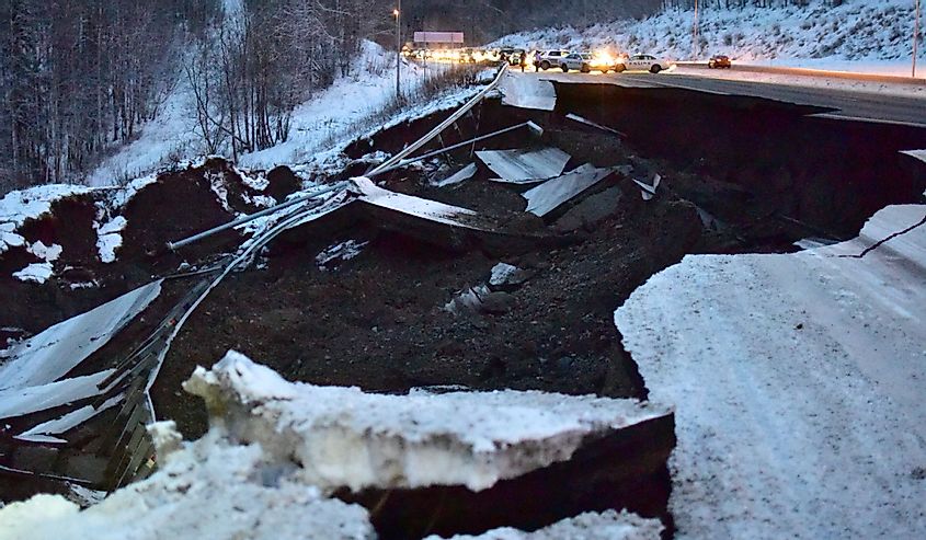 Police block traffic on the Glenn Highway north of Anchorage, Alaska, due to damage from a magnitude 7.0 earthquake.