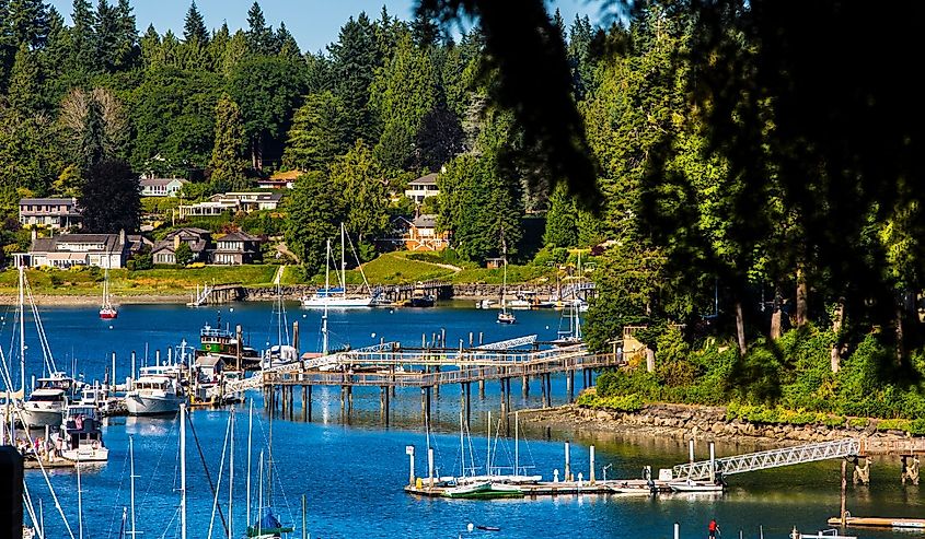 Bainbridge Island, Washington State. People enjoying waterfront and boats on a marina in the Puget Sound