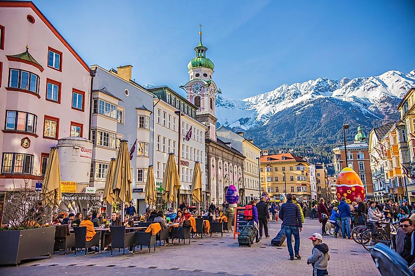 Innsbruck town center with lots of people and street cafes decorated for Easter holidays with big Easter eggs, Innsbruck, Tyrol, Austria