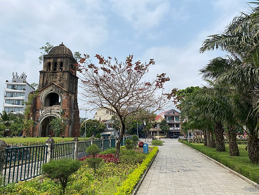The ruins of a church bombed during the Vietnam War are contrasted by a lovely public park.