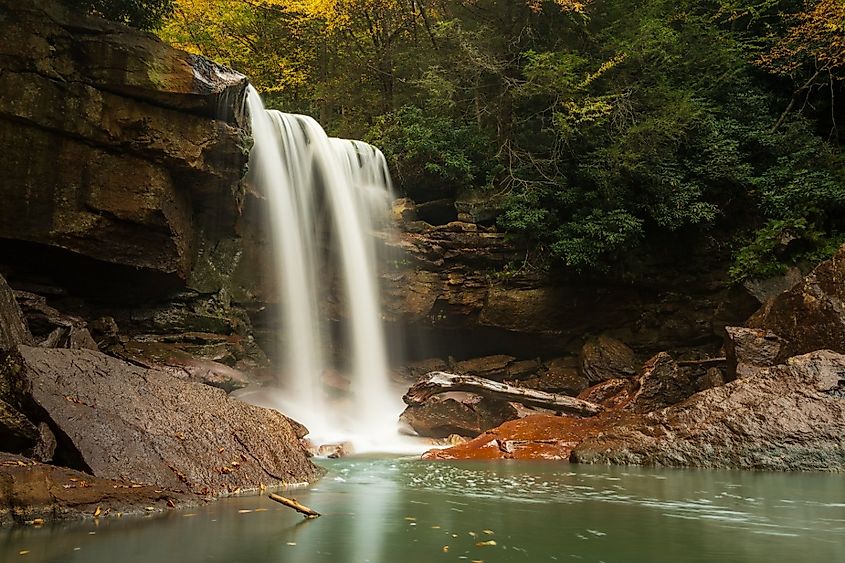 Twin cascades of Douglas Falls and calm lagoon stained with the remains of West Virginia coal mining near Thomas, West Virginia.